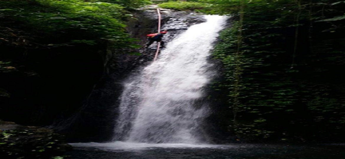 Beginner canyoning rappel at Yeh Lampah waterfall in North Bali