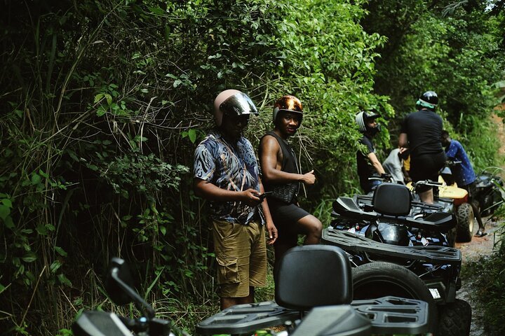 Guided ATV tour on jungle trail, rider with helmet