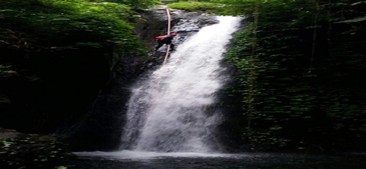 Beginner canyoning rappel at Yeh Lampah waterfall in North Bali