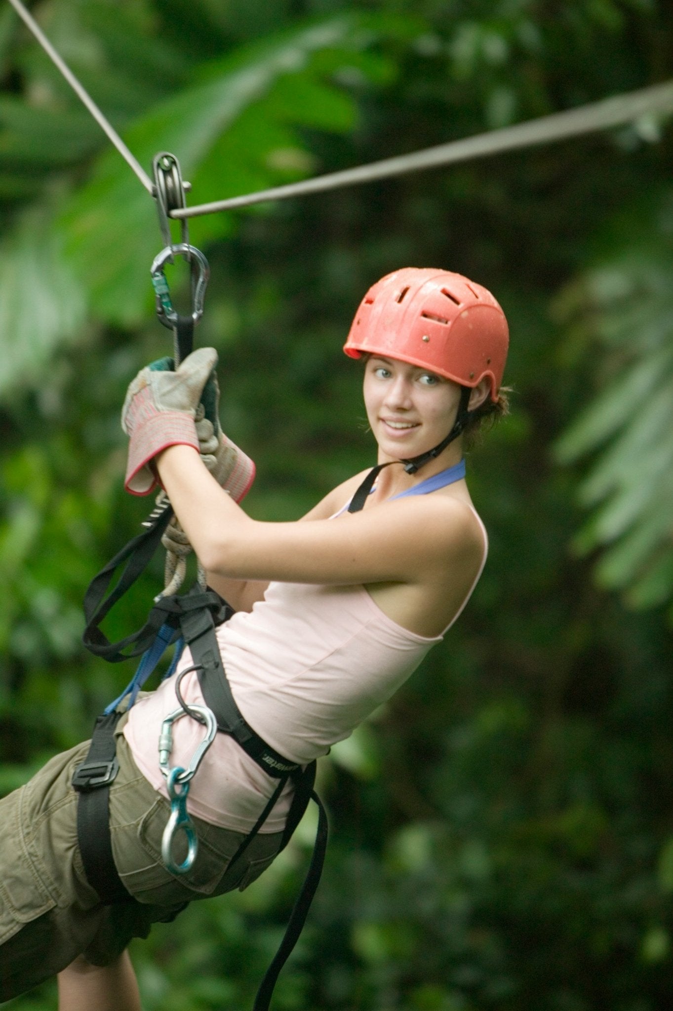 Close-up of participant braking on jungle zipline
